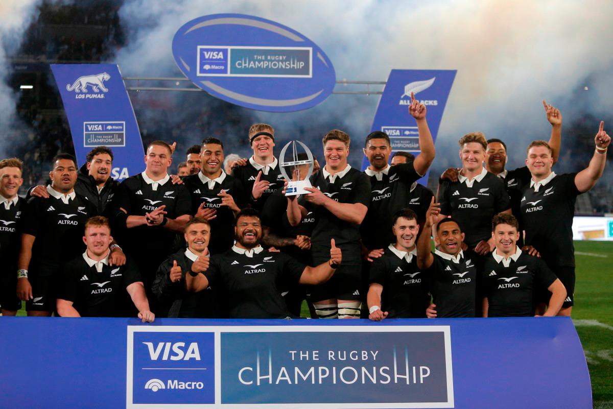 New Zealand’s All Blacks players pose with their trophy after winning the Rugby Championship 2025 match between Argentina and New Zealand at Mario Alberto Kempes stadium in Cordoba, Argentina - AFP