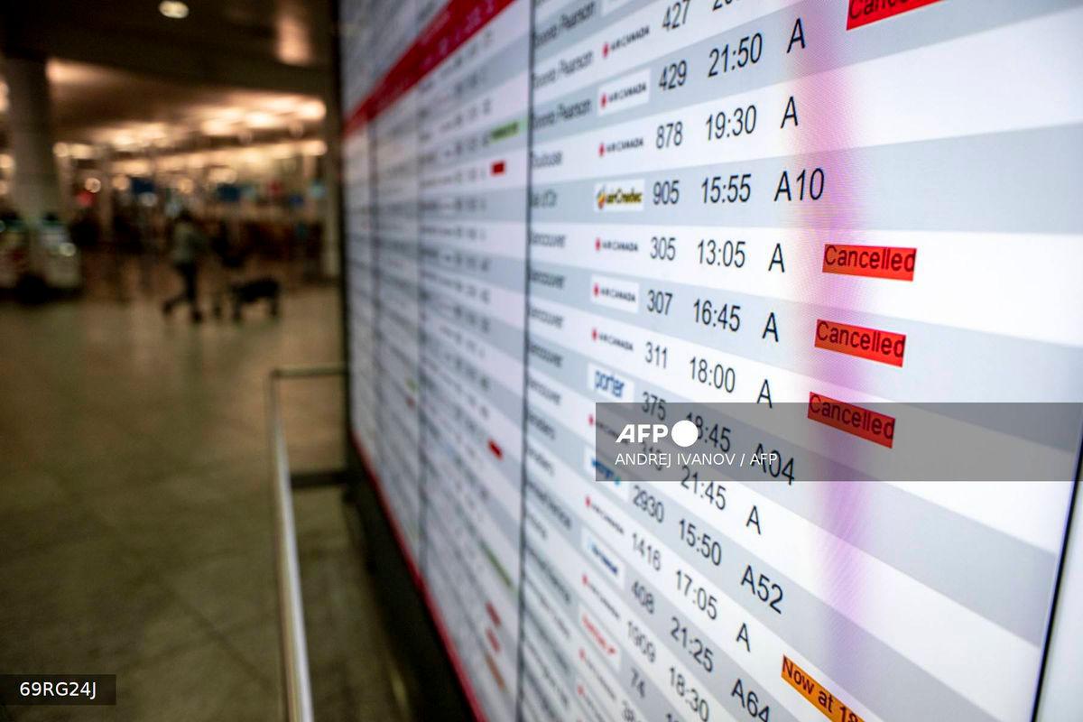 A flight board is seen with many cancellations for Air Canada flights at Pierre-Elliott Trudeau Airport in Montreal, Quebec, Canada, on August 17, 2025. (Photo by ANDREJ IVANOV / AFP)