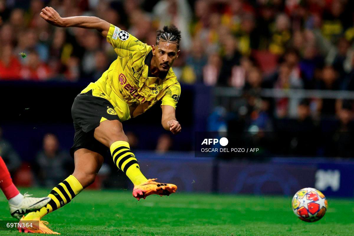 Dortmund's French-Ivorian forward #09 Sebastien Haller kicks the ball to score his team's first goal during the UEFA Champions League quarter final first leg football match between Club Atletico de Madrid and Borussia Dortmund at the Metropolitano stadium in Madrid on April 10, 2024. - AFP