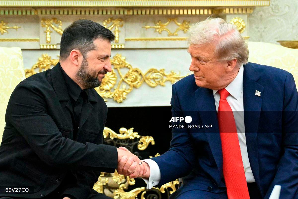 Ukrainian President Volodymyr Zelensky and US President Donald Trump shake hands during a meeting in the Oval Office of the White House in Washington, DC, on August 18, 2025. - AFP