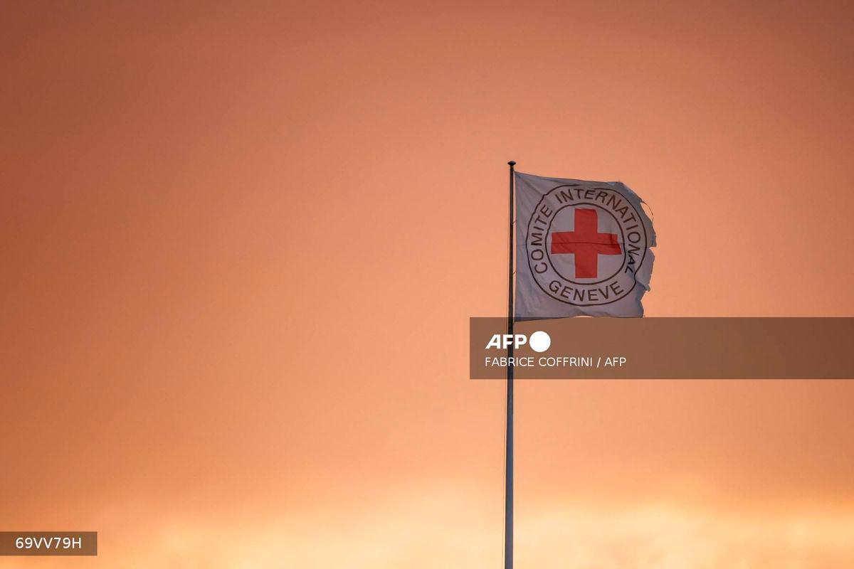 A flag of the Comite International Geneve (International Committee of the Red Cross ICRC) is seen fluttering in the wind on the top of the humanitarian organization's headquarters in Geneva, on August 14, 2025. - AFP