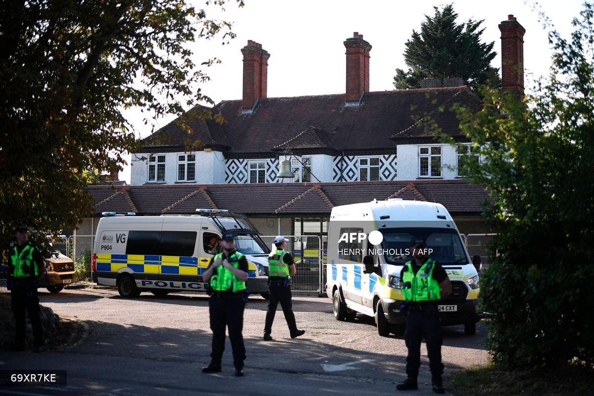 Police officers stand outside the The Bell Hotel, believed to be housing asylum seekers, in Epping, northeast of London, on August 8, 2025, as protests are expected from far right groups. (Photo by HENRY NICHOLLS / AFP)