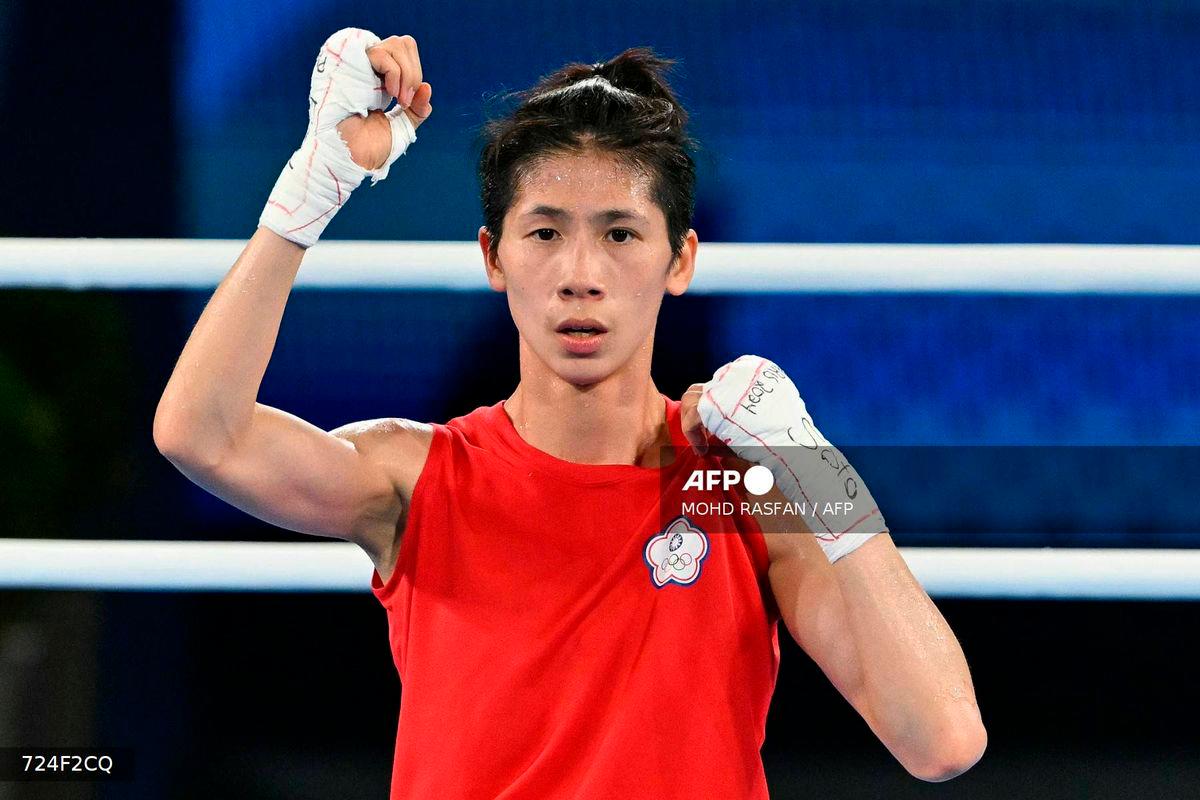 Taiwan’s Lin Yu-ting reacts after beating Poland’s Julia Szeremeta (Blue) in the women’s 57kg final boxing match during the Paris 2024 Olympic Games at the Roland-Garros Stadium, in Paris on August 10, 2024. (Photo by MOHD RASFAN / AFP)