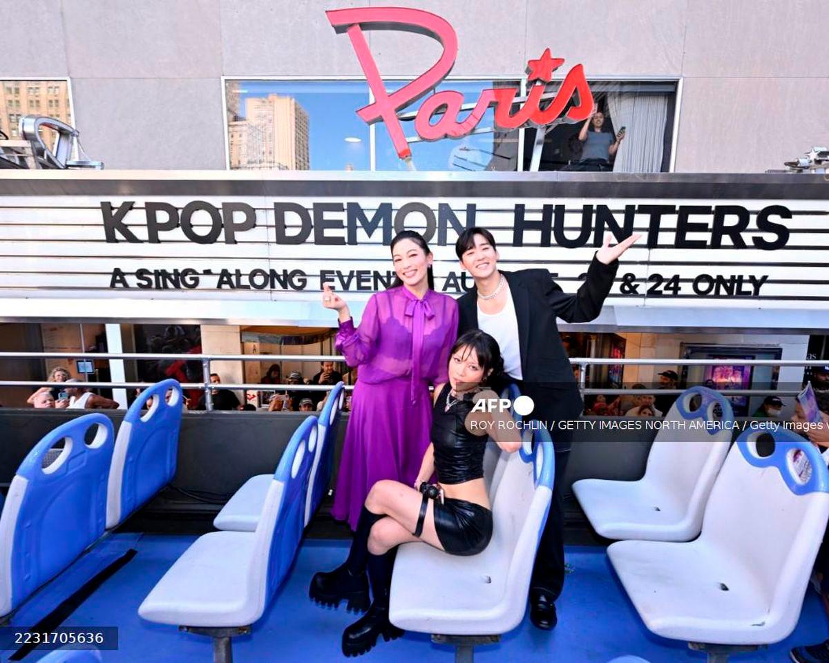 (L-R) Arden Cho, REI AMI and Kevin Woo hop on the KPop Demon Hunters-Sing Along Experience at Paris Theater on August 23, 2025 in New York City. - Getty Images via AFP