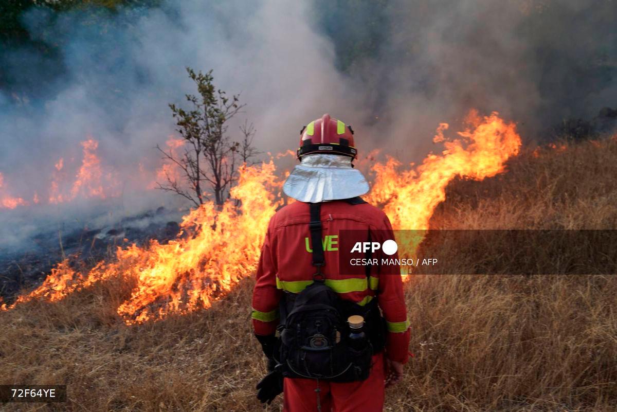 A member of Spain's Military Emergency Unit (UME) tackles a wildfire in Garano, northwestern Spain, on August 25, 2025. - AFP