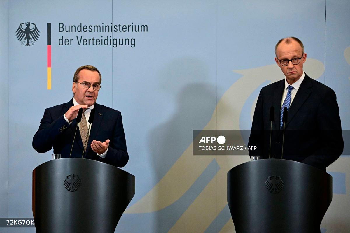 German Chancellor Friedrich Merz (R) listens as German Defence Minister Boris Pistorius addresses a joint press conference following a cabinet meeting held exceptionally at the Bendlerblock, seat of the Federal Ministry of Defence, in Berlin on August 27, 2025. - Tobias SCHWARZ / AFP