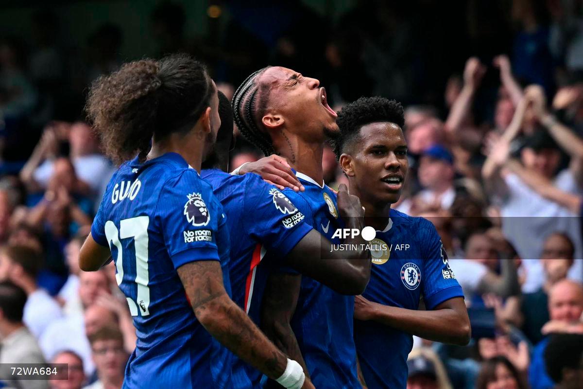 Chelsea's Brazilian striker #20 Joao Pedro (C) celebrates with teammates after scoring the opening goal during the English Premier League football match between Chelsea and Fulham at Stamford Bridge in London on August 30, 2025. - AFP