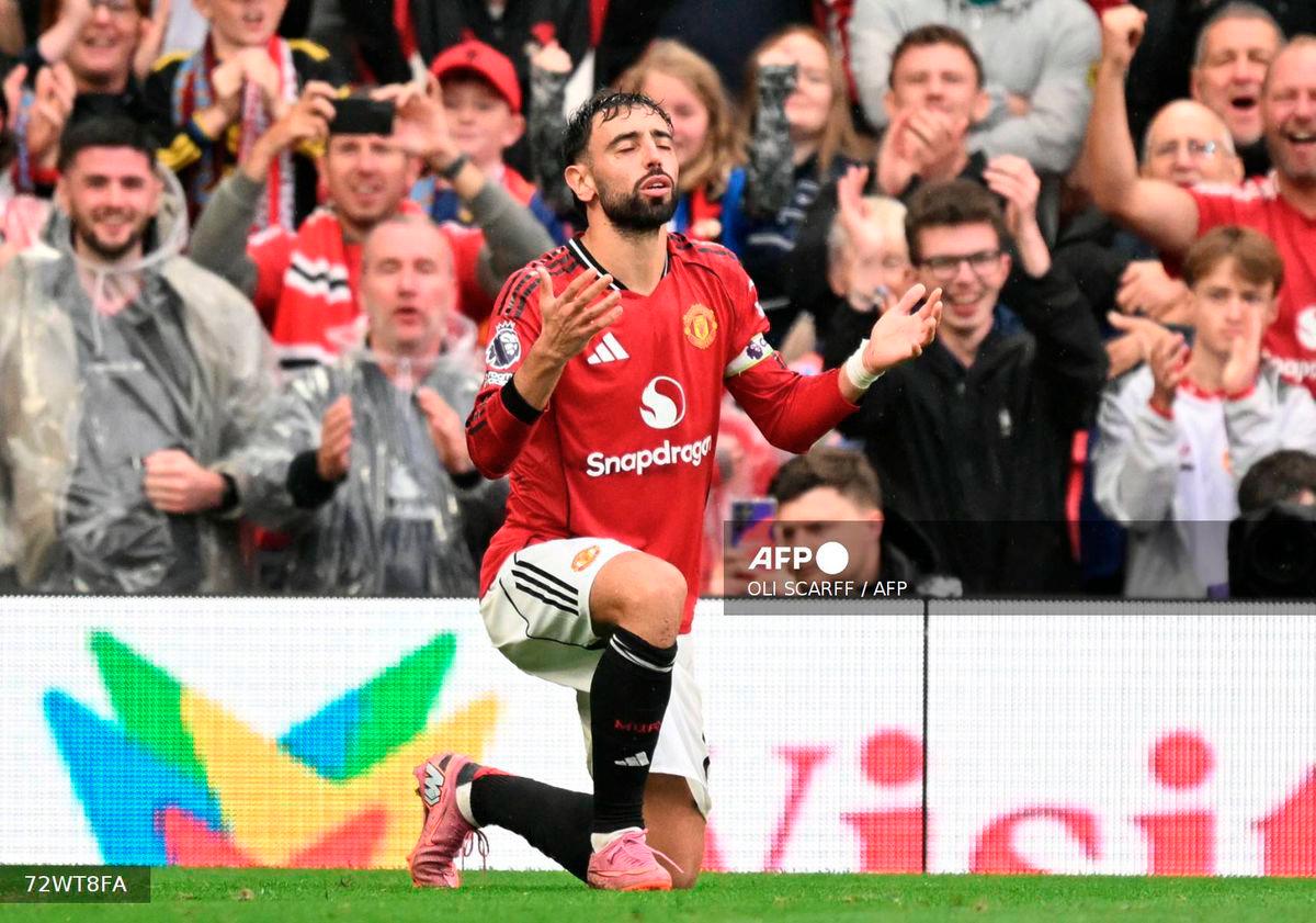 Manchester United's Portuguese midfielder #08 Bruno Fernandes celebrates scoring their third goal from the penalty spot during the English Premier League football match between Manchester United and Burnley at Old Trafford in Manchester, north west England, on August 30, 2025. - AFP
