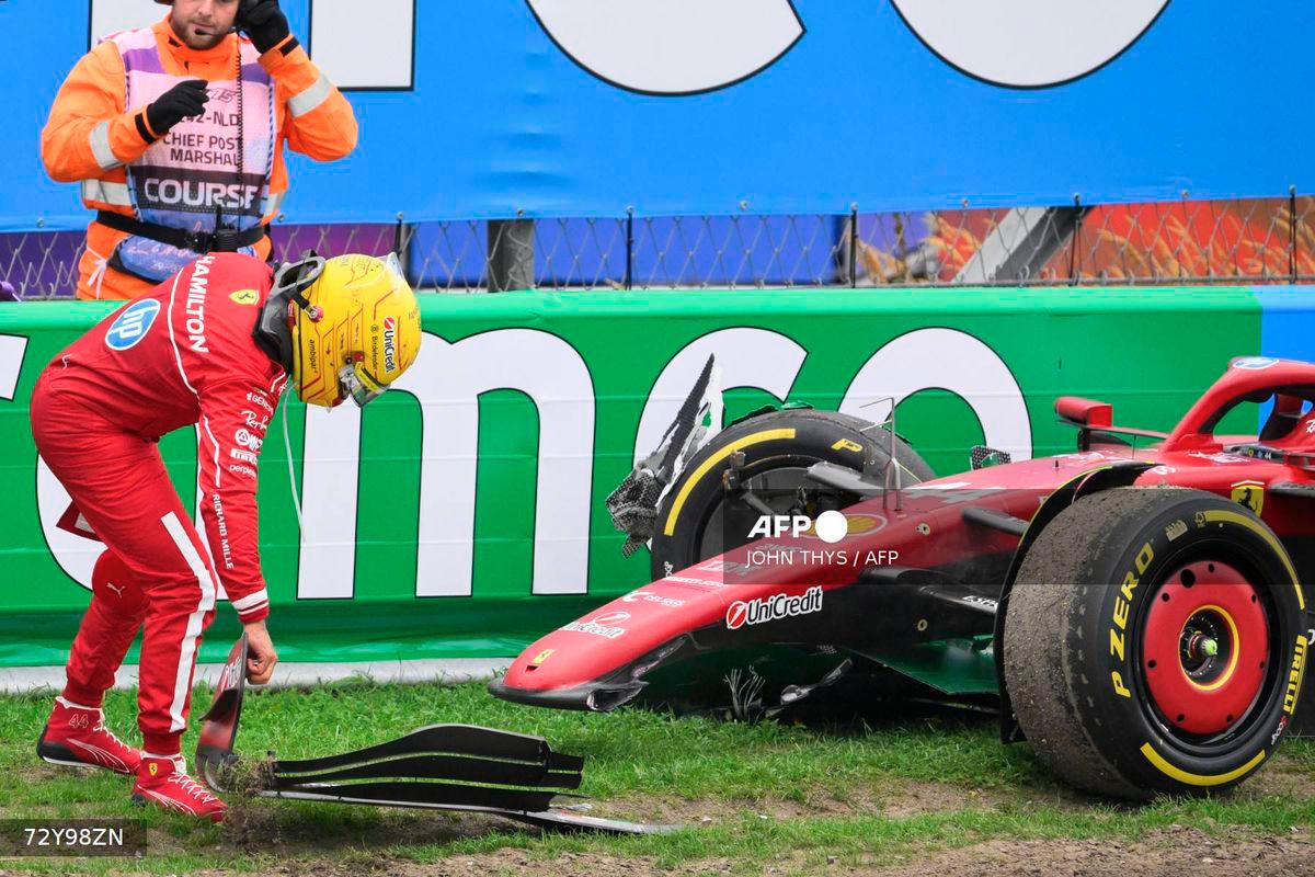 Ferrari's British driver Lewis Hamilton moves a piece of his front wing after crashing during the Formula One Dutch Grand Prix at The Circuit Zandvoort, western Netherlands, on August 31, 2025. - AFP