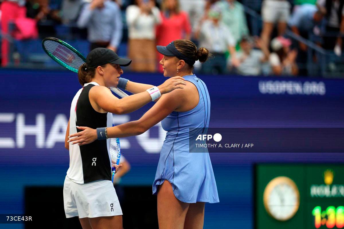 USA's Amanda Anisimova (R) and Poland's Iga Swiatek hug after Anisimova won their women's singles quarterfinal tennis match on day eleven of the US Open tennis tournament at the USTA Billie Jean King National Tennis Center in New York City on September 3, 2025. - AFP