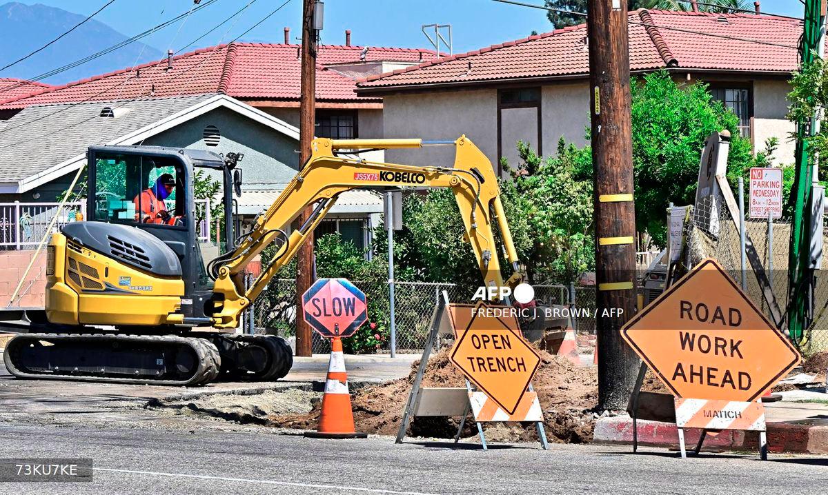 A construction worker operates an excavator at a work site in San Gabriel, California on September 5, 2025. - AFP
