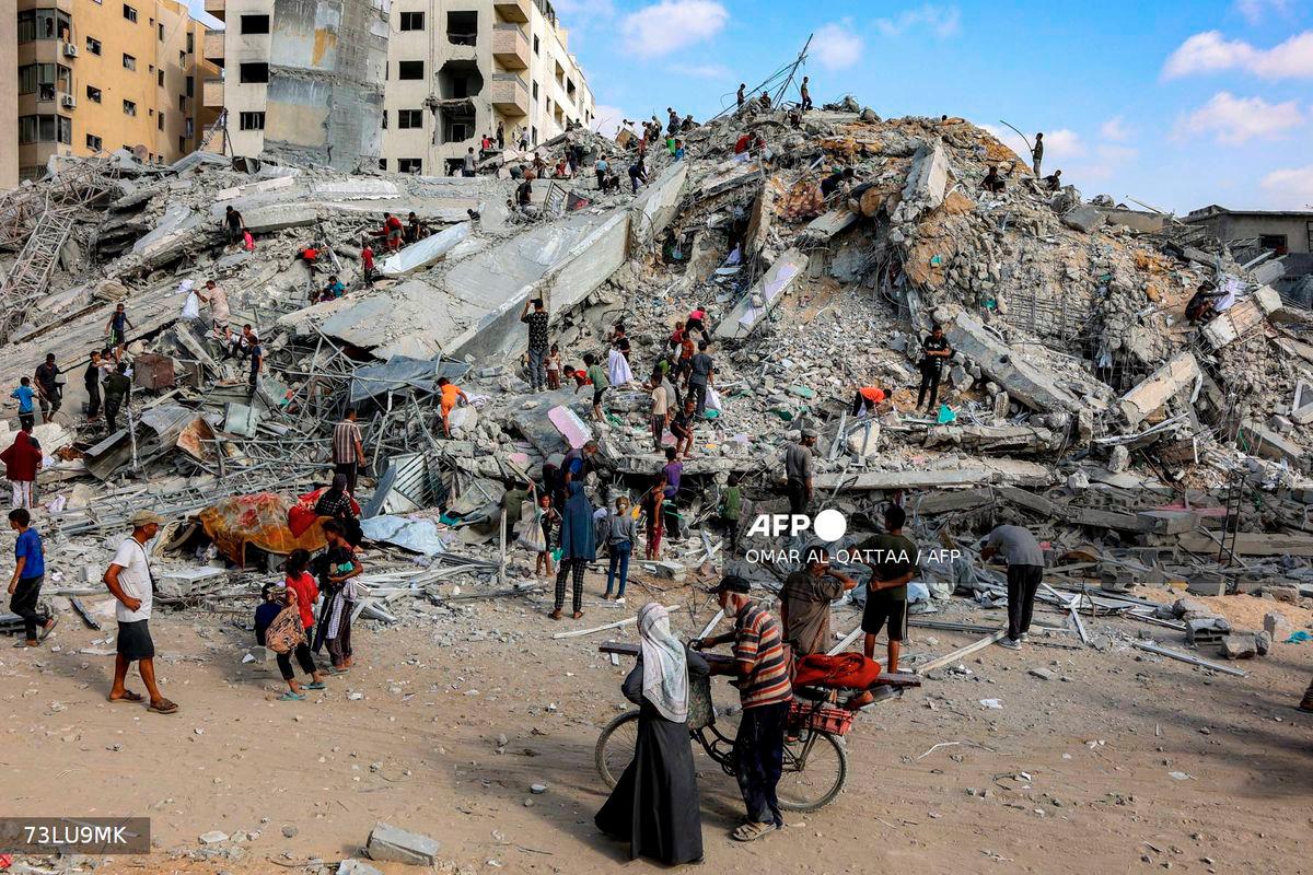 People search for salvage at the mound of rubble at the site of the collapsed Sussi Tower, which was destroyed earlier by Israeli bombardment, in Gaza City on September 6, 2025. - AFP