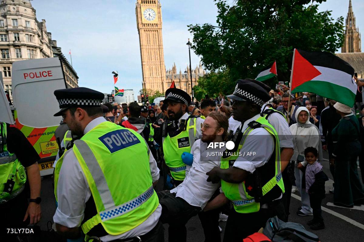 A protester is carried away by police officers at a Lift The Ban demonstration in support of the proscribed group Palestine Action, calling for the recently imposed ban to be lifted, in Parliament Square, central London, on September 6, 2025. - AFP