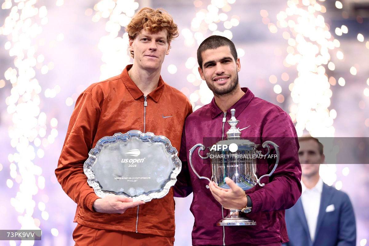 Spain’s Carlos Alcaraz (R) and Italy’s Jannik Sinner (L) pose for a photo after their men's singles final tennis match on day fifteen of the US Open tennis tournament at the USTA Billie Jean King National Tennis Center in New York City, on September 7, 2025. - AFP
