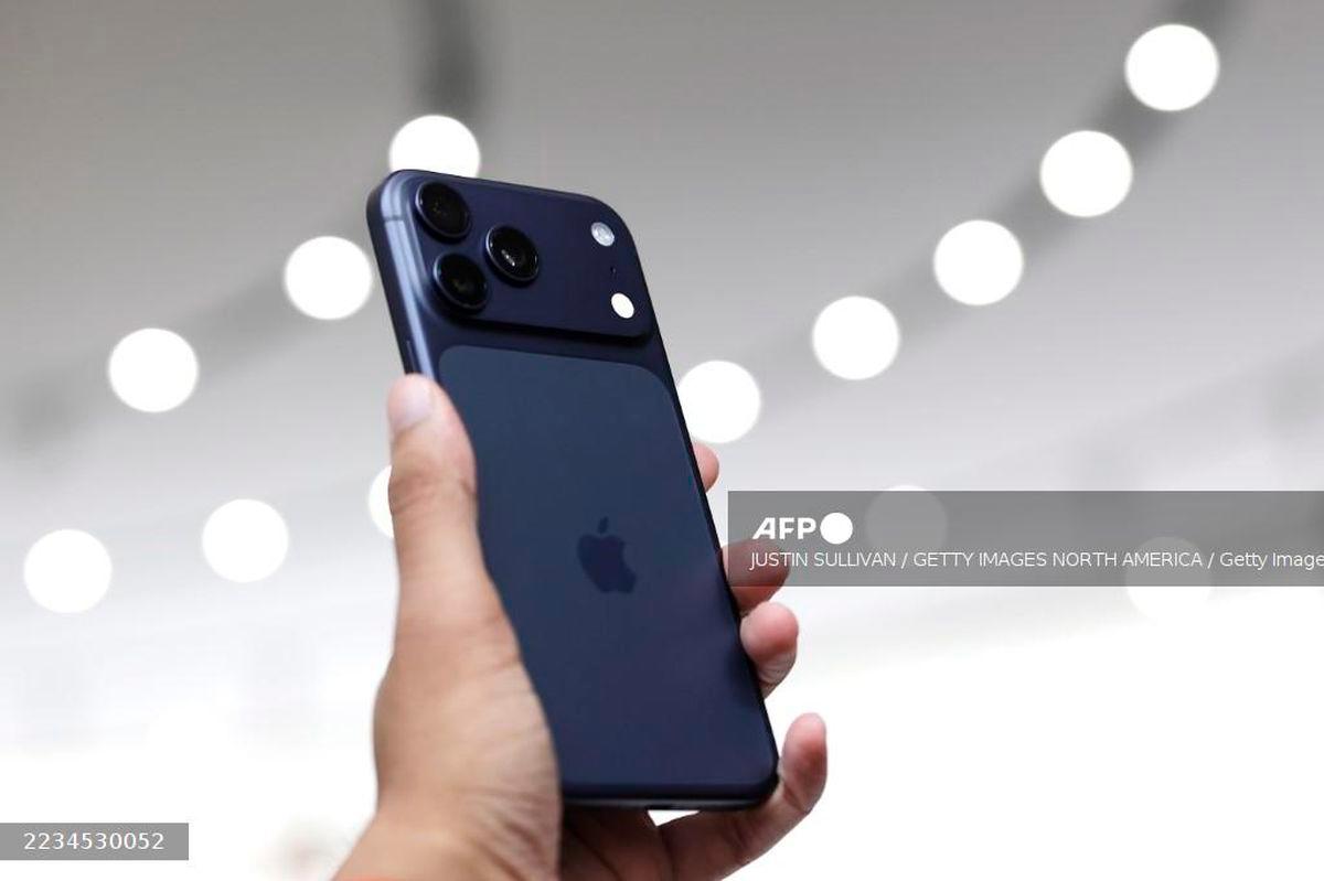A next generation iPhone 17 is held during an Apple special event at Apple headquarters on September 9, 2025 in Cupertino, California. - Getty Images via AFP