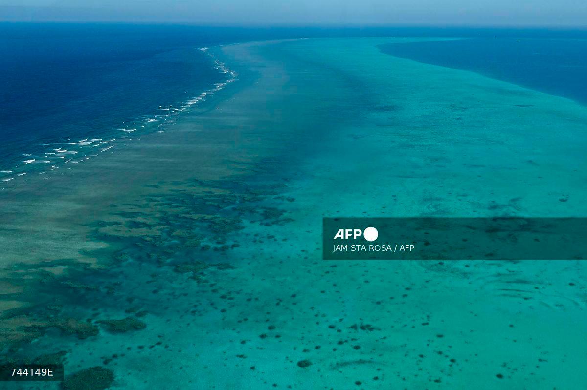 (FILES) This photo taken on February 15, 2024 shows an aerial view over the Scarborough Shoal in the disputed South China Sea. The Philippines protested on September 11, 2025 against a Chinese scheme to create a “nature reserve” on the disputed Scarborough Shoal, the site of repeated clashes in the South China Sea. (Photo by JAM STA ROSA / AFP)
