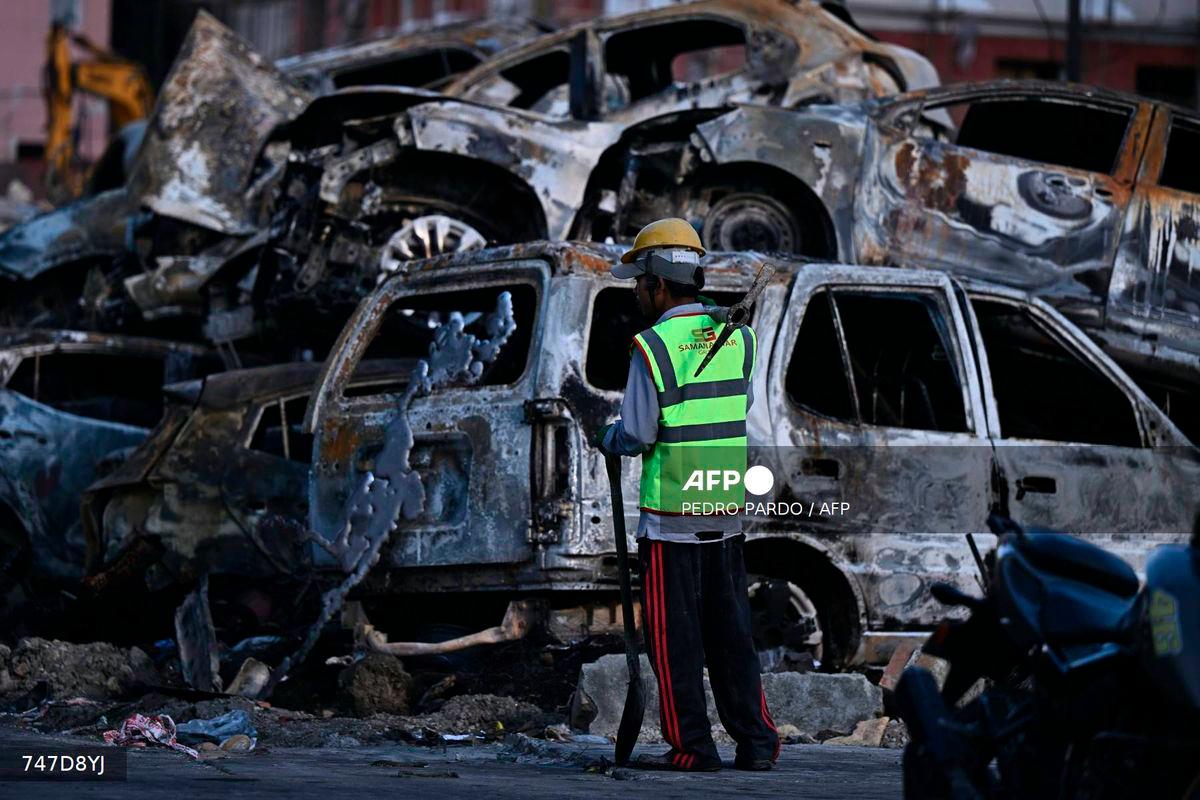 Burnt cars are pictured outside the Supreme Court during a curfew imposed to restore law and order in Kathmandu on September 11, 2025. - AFP