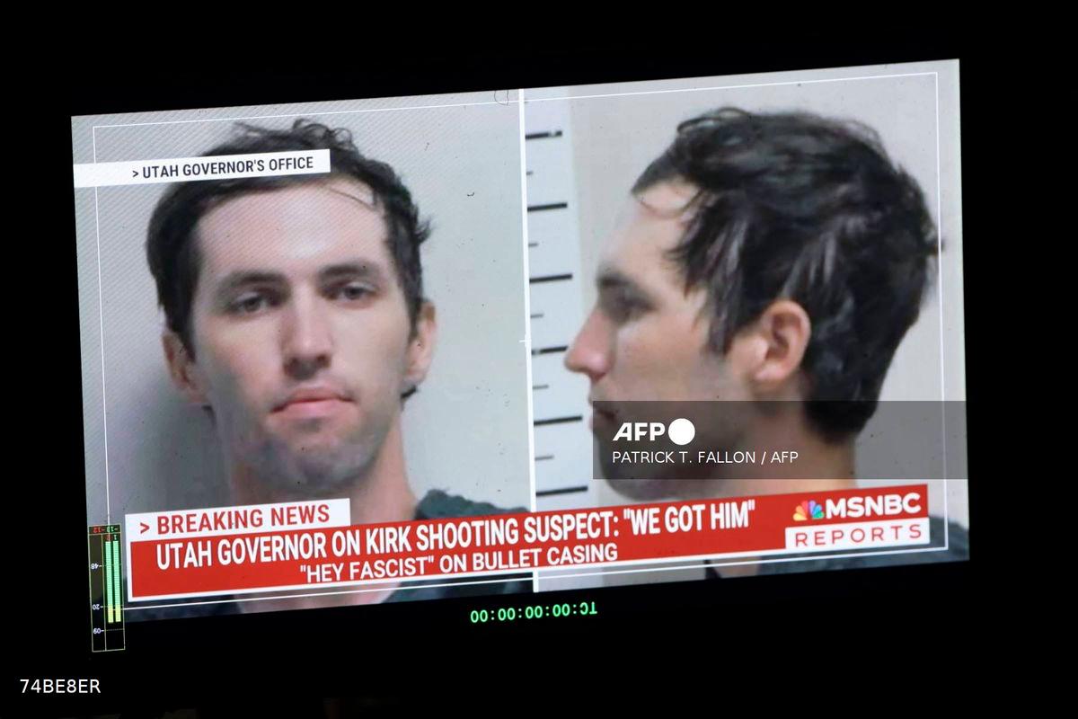 A TV monitor displays a picture of Tyler Robinson, the suspected of killing Charlie Kirk on September 11, in Orem, Utah, on September 12, 2025. (Photo by Patrick T. Fallon / AFP)
