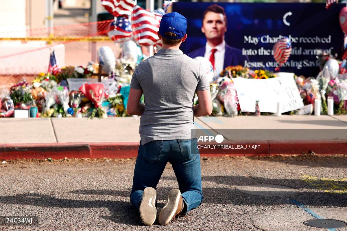 A man mourns Turning Point USA founder Charlie Kirk at a memorial set up outside of the Turning Point USA headquarters on September 12, 2025 in Phoenix, Arizona. US President Donald Trump on Friday announced that the suspect had been taken into custody over the killing of right-wing activist Charlie Kirk after a massive manhunt.