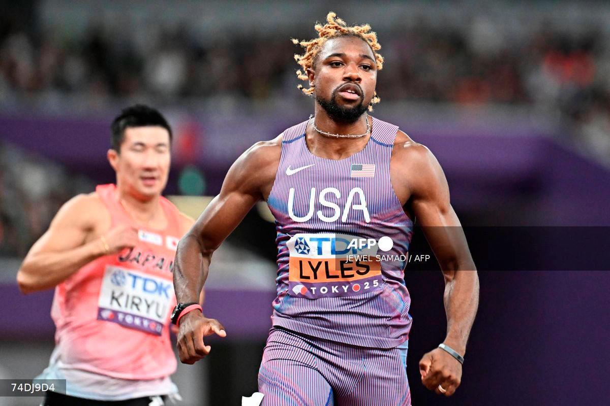 Japan's Yoshihide Kiryu (L) and US sprinter Noah Lyles react after competing in the men's 100m heats during the World Athletics Championships in Tokyo on September 13, 2025. - AFP