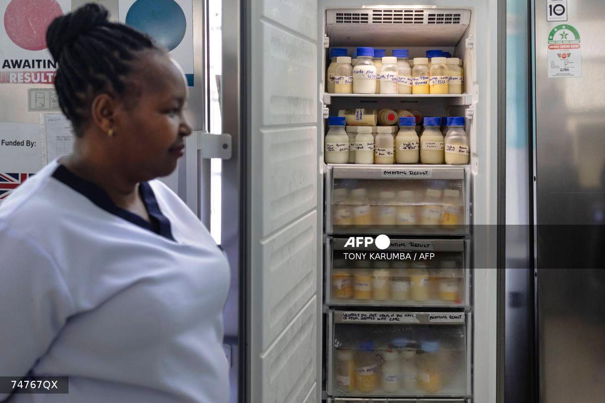 Hannah Wangeci Maina, a senior nurse stands near reserves of donated breastmilk preserved in a freezer to await screening at a human milk bank in the Pumwani Maternity Hospital, Nairobi on September 4, 2025. (Photo by Tony KARUMBA / AFP)