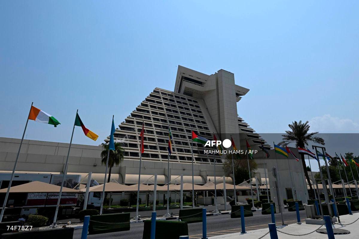Flags fly in front of the hotel where the upcoming Arab-Islamic summit, organised to discuss the recent Israeli attack on Qatar will take place, in Doha on September 14, 2025. (Photo by MAHMUD HAMS / AFP)