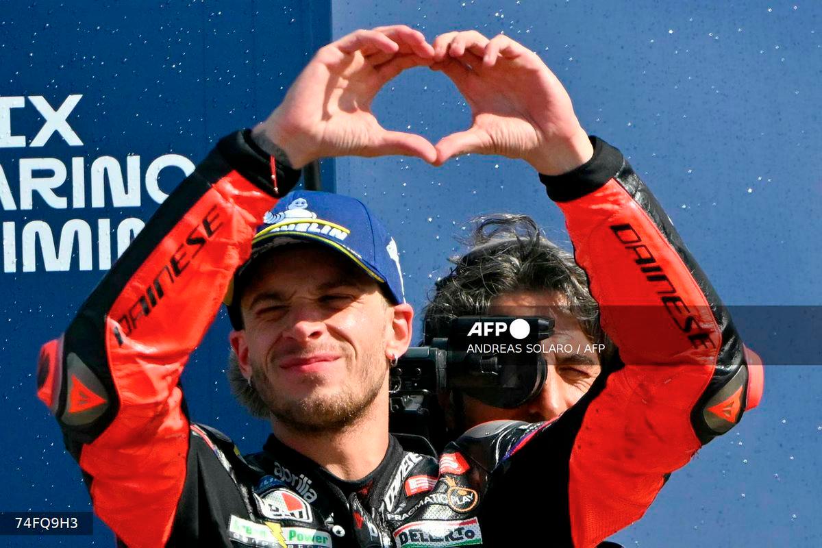 Aprilia Racing team's Italian MotoGP rider Marco Bezzecchi celebrates his second place at the end of the San Marino Moto GP Grand Prix at the Misano World Circuit Marco Simoncelli, in Misano Adriatico, northern Italy, on September 14, 2025. - AFP