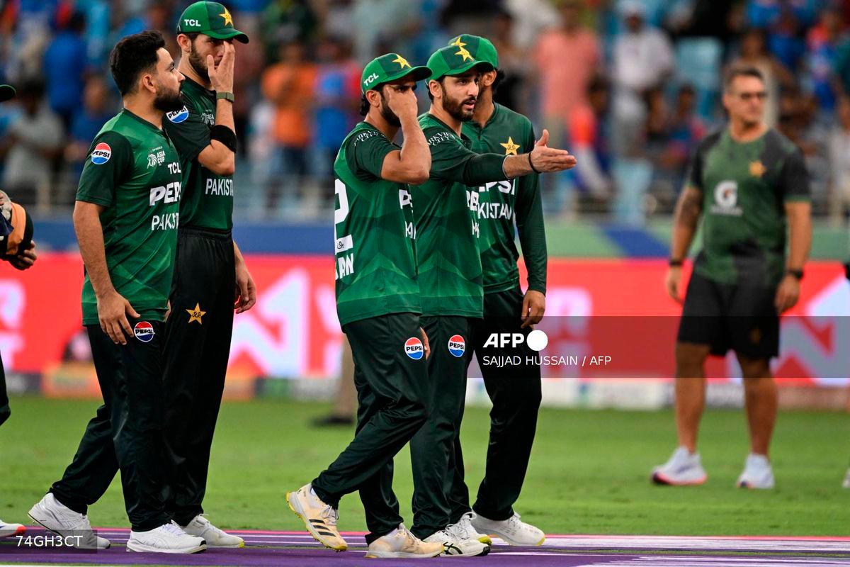 Pakistan’s players walk back to the pavilion at the end of the Asia Cup 2025 Twenty20 international cricket match against India at the Dubai International Stadium in Dubai on September 14, 2025. (Photo by SAJJAD HUSSAIN / AFP)