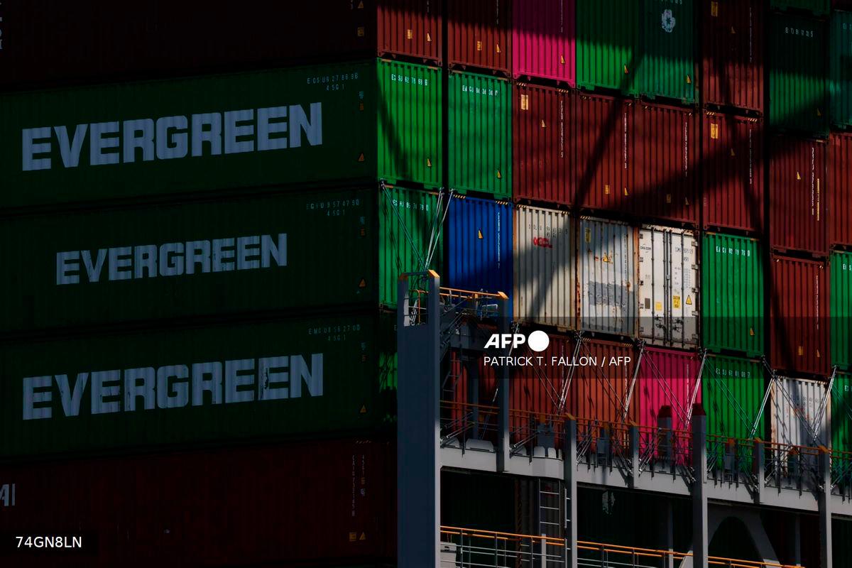 Evergreen cargo shipping containers stand stacked on a cargo container ship docked at the Evergreen shipping terminal at the Port of Los Angeles in Los Angeles, California on September 13, 2025. - AFP