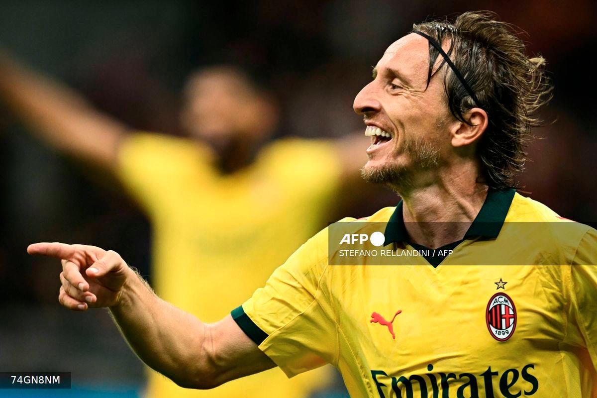 AC Milan's Croatian midfielder #14 Luka Modric celebrates after scoring his team first goal during the Italian Serie A football match between AC Milan and Bologna at San Siro stadium in Milan, northern Italy, on September 14, 2025. - AFP