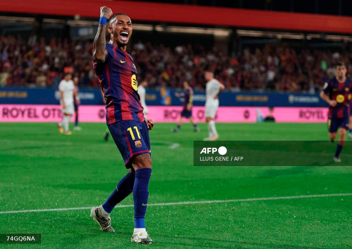 Barcelona's Brazilian forward #11 Raphinha celebrates scoring his team's fourth goal during the Spanish league football match between FC Barcelona and Valencia CF at Johan Cruyff Stadium in Barcelona, on September 14, 2025. - AFP