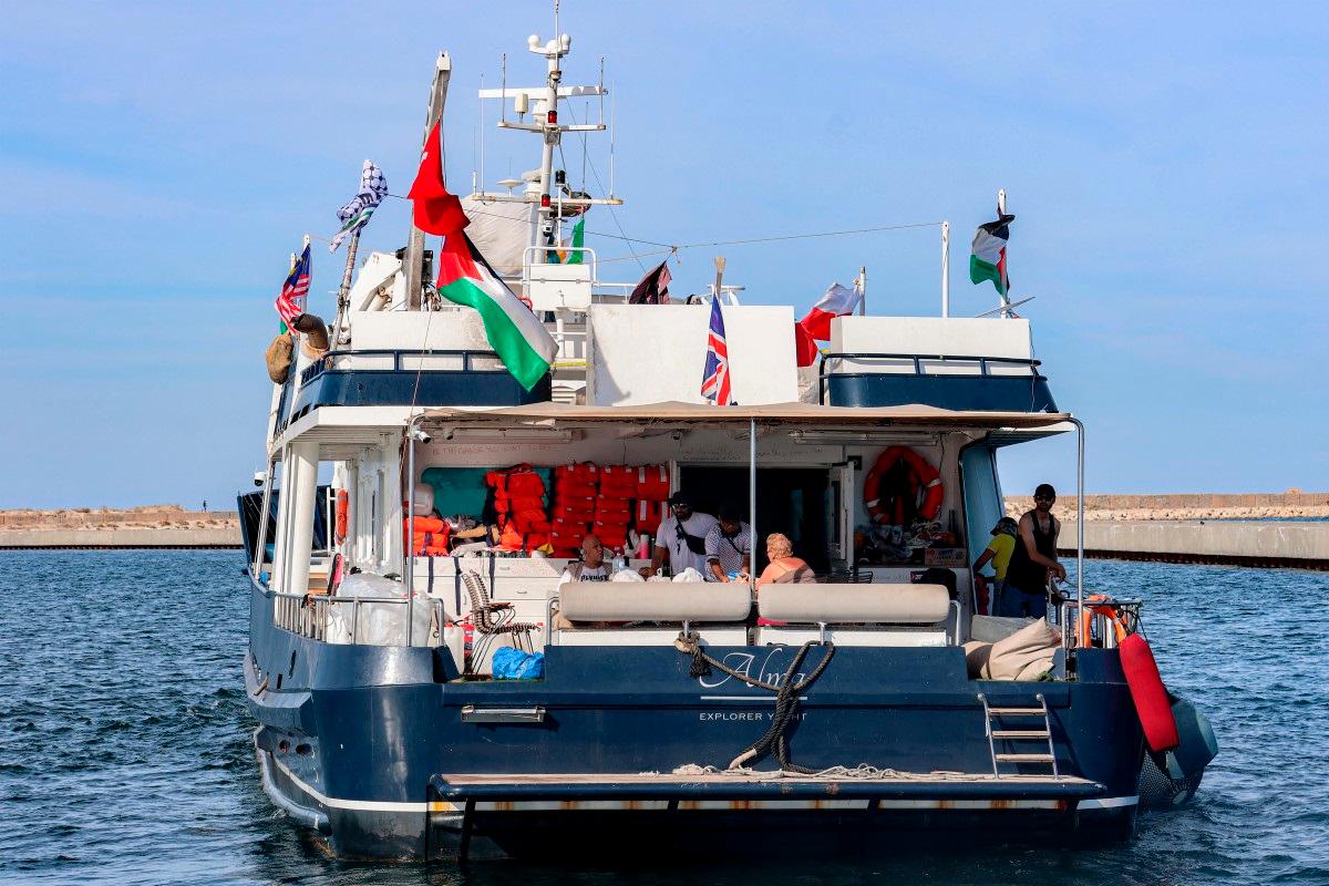 Activists and human rights defenders ride aboard the yacht Alma, departing from Tunisia’s northern port of Bizerte, on September 14, 2025 to join the last boats taking part in the Global Sumud Flotilla, bound for the Gaza Strip to break Israel’s blockade on the Palestinian territory. - MOHAMED FLISS / AFP