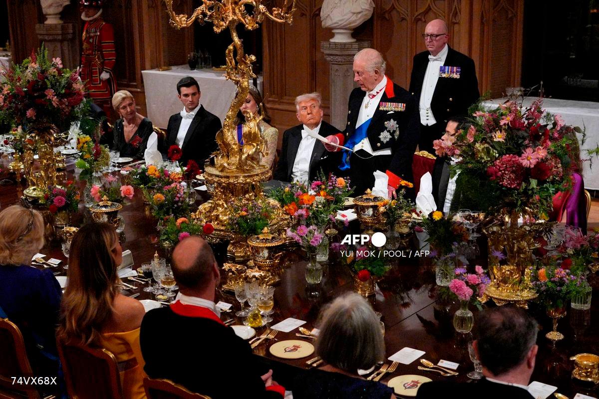 US President Donald Trump looks on as Britain’s King Charles III delivers a speech during a State Banquet at Windsor Castle, in Windsor, on September 17, 2025, during the US President’s second State Visit. (Photo by Yui Mok / POOL / AFP)