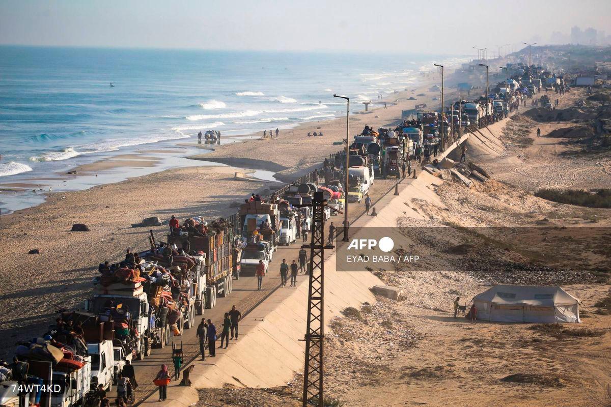 Displaced Palestinians move with their belongings southwards on a road in the Nuseirat refugee camp area in the central Gaza Strip following renewed Israeli evacuation orders for Gaza City on September 18, 2025. - AFP