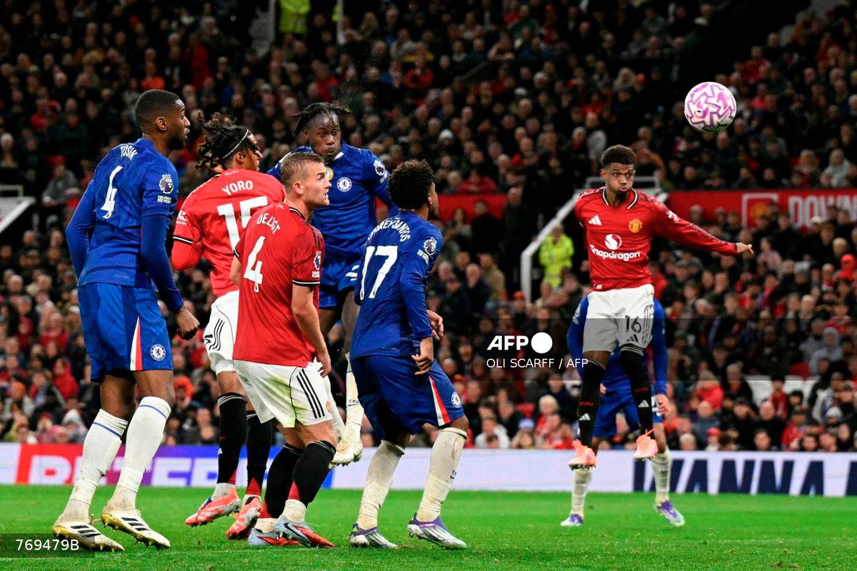 Chelsea's English defender #23 Trevoh Chalobah scores the team's first goal during the English Premier League football match between Manchester United and Chelsea at Old Trafford in Manchester, north west England, on September 20, 2025. - AFP