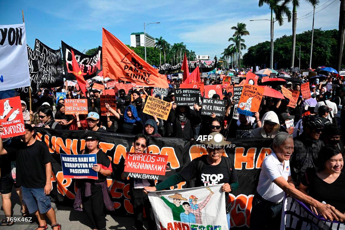 Protesters take part in a rally as they demonstrate against phony flood control projects, one of the country's biggest corruption scandals in decades, in Manila on September 21, 2025. - AFP