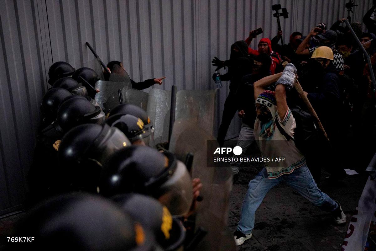 Protesters clash with riot police during an anti-government demonstration in Lima on September 20, 2025. - AFP