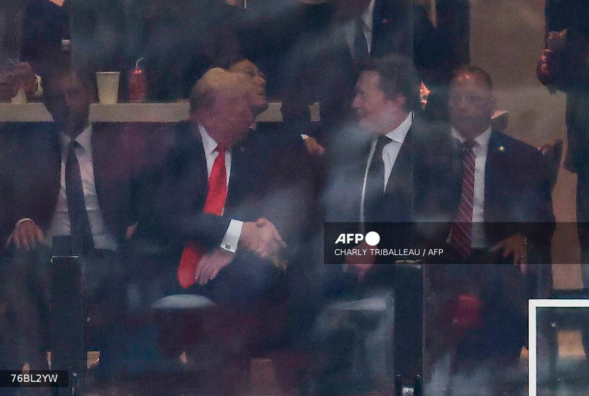 US President Donald Trump and Tesla CEO Elon Musk shake hands during the public memorial service for right-wing activist Charlie Kirk at State Farm Stadium in Glendale, Arizona, on September 21, 2025. - AFP