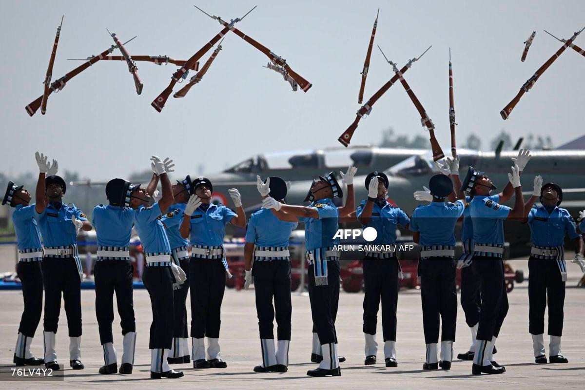 Indian Air force cadets toss their rifles during a full dress rehearsal ahead of MIG-21 Bison fighter jet farewell at Chandigarh Airforce Station on September 24, 2025. - AFP