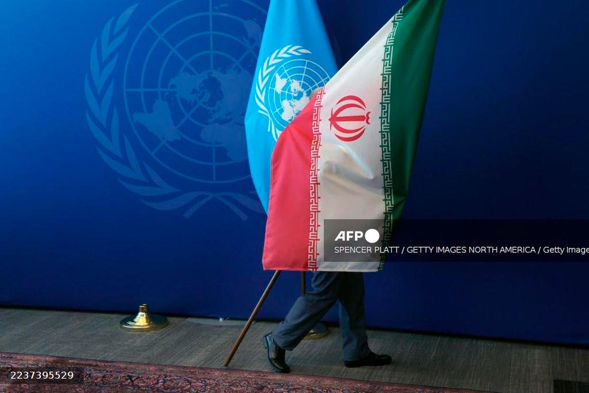 The Iranian flag is taken out of the room after Iranian President Masoud Pezeshkian met with the United Nations (UN) Secretary General Antonio Guterres during the UN's General Assembly on September 25, 2025, in New York City. - AFP