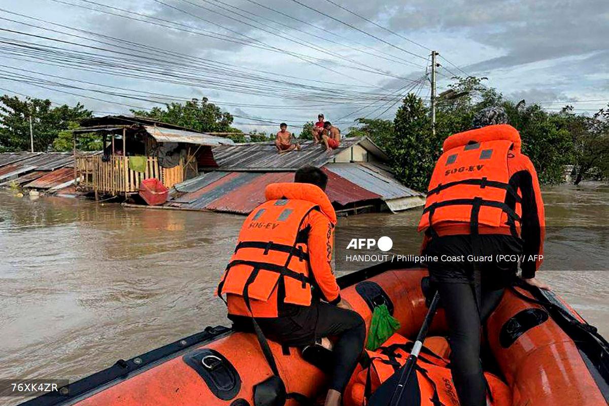 This handout photo taken on September 26, 2025 and released on September 27 by the Philippine Coast Guard shows coast guard personnel rescuing residents from their flooded house at the height of Severe Tropical Storm Bualoi, at a village in Ormoc City, Leyte province- AFP PHOTO / PHILIPPINE COAST GUARD
