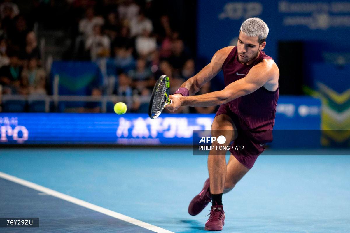 Spain’s Carlos Alcaraz hits a return against Belgium’s Zizou Bergs during their men’s singles match at the ATP Japan Open tennis tournament in Tokyo on September 27, 2025. (Photo by Philip FONG / AFP)