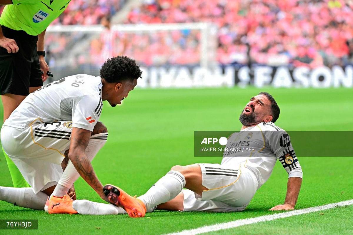 Real Madrid's Spanish defender #02 Dani Carvajal reacts on the ground during the Spanish league football match between Club Atletico de Madrid and Real Madrid CF at the Metropolitano stadium in Madrid on September 27, 2025. - AFP
