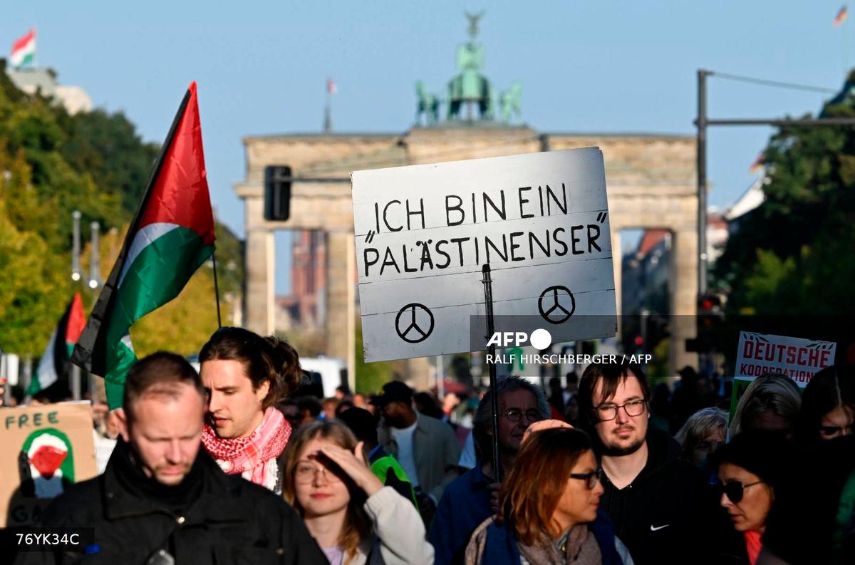 Participants march with a placard reading ‘I am a Palestinian’ during a demonstration under the motto ‘Draw the red line with us: Together for Gaza!’ near the Brandenburg Gate in the center of Berlin on September 27, 2025. (Photo by RALF HIRSCHBERGER / AFP)