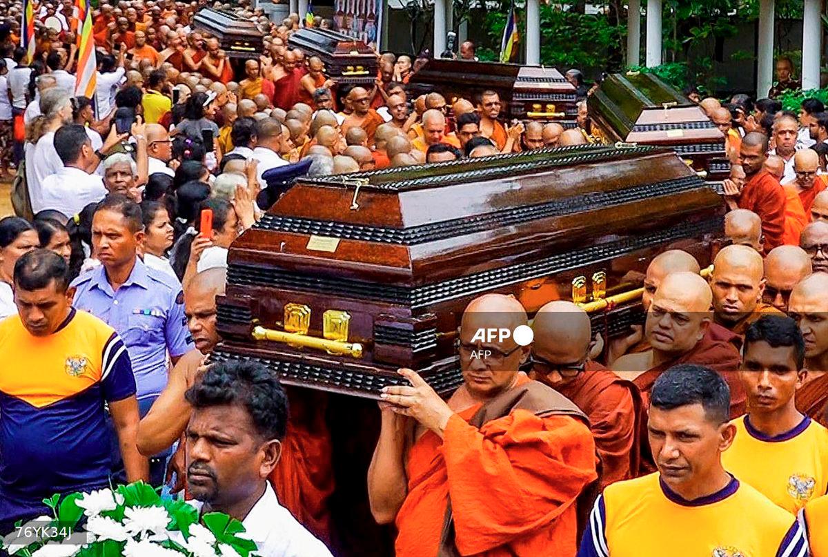Buddhist monks carry coffins of fellow monks during a funeral ceremony at the Na Uyana Monastery in Melsiripura on September 27, 2025. - AFP