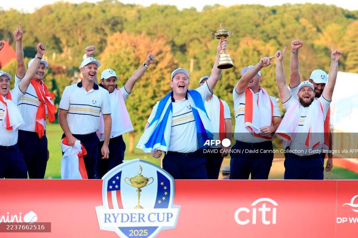 Robert MacIntyre of Europe holds the Ryder Cup trophy aloft as Team Europe celebrate their 15-13 victory during the trophy presentation ceremony following the Sunday singles matches of the 2025 Ryder Cup at Black Course at Bethpage State Park Golf Course on September 28, 2025 in Farmingdale, New York. - Getty Images via AFP