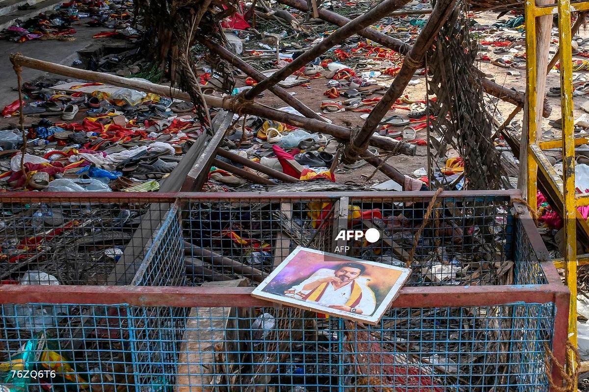 A portrait of actor-turned-politician Vijay is seen near the scattered shoes after a stampede that broke out last evening during his political rally in the Karur district, in the Indian state of Tamil Nadu, on September 28, 2025. (Photo by AFP) / ALTERNATE CROP