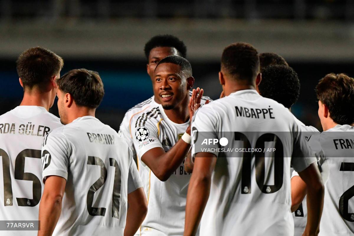 Real Madrid's French forward #10 Kylian Mbappe (R) and Real Madrid's Austrian defender #04 David Alaba (C) celebrate scoring their team's third goal during the UEFA Champions League first round day 2 football match between Kairat Almaty and Real Madrid at the Almaty Ortalyk stadion in Almaty on September 30, 2025. - AFPPIX