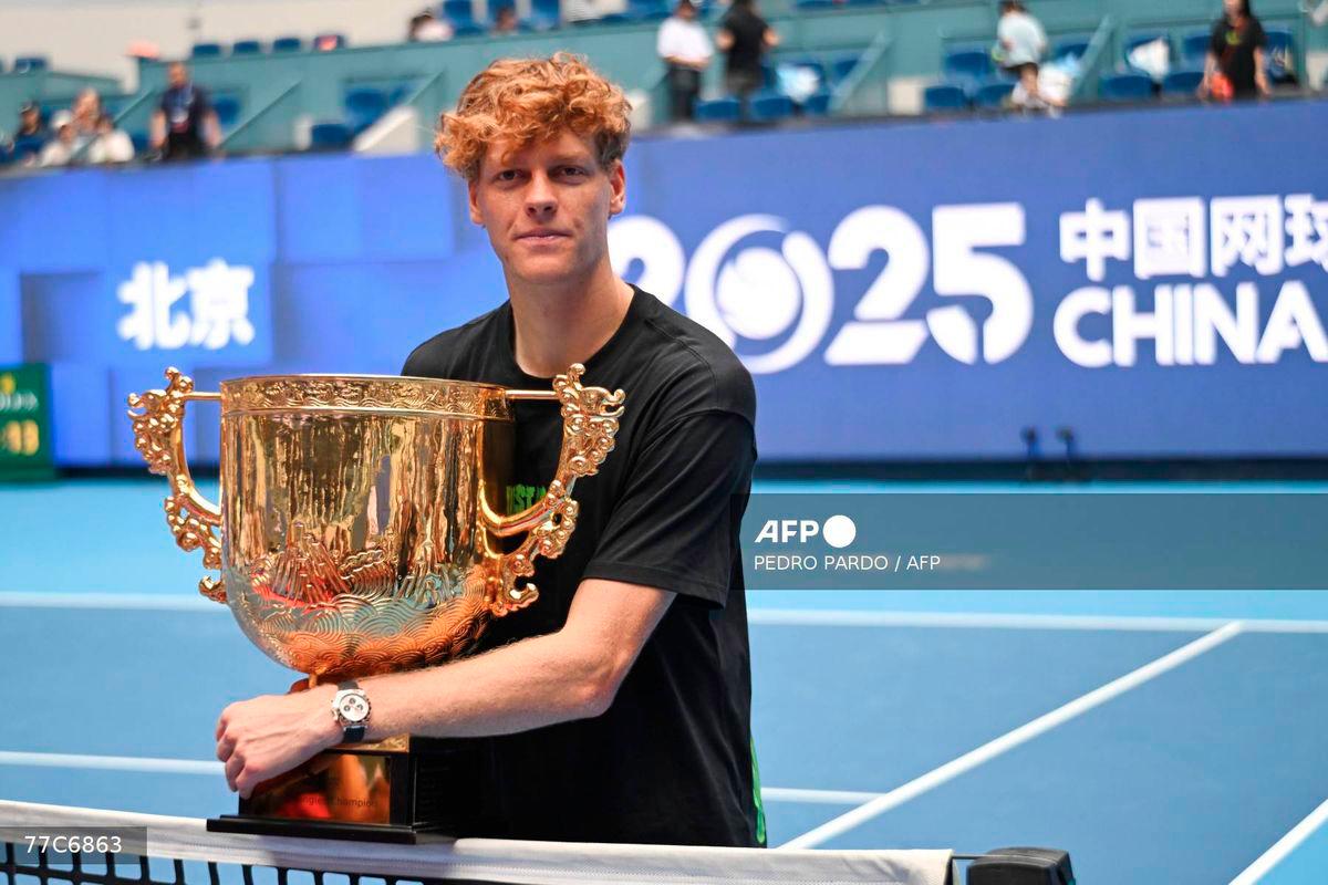 Italy’s Jannik Sinner poses with his trophy after winning the men’s singles final against USA’s Learner Tien at the China Open tennis tournament in Beijing on October 1, 2025. - AFP