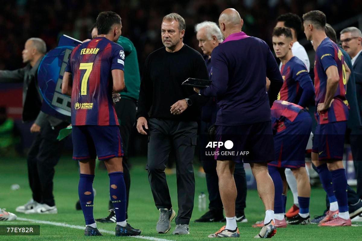 Barcelona's German coach Hans-Dieter Flick (2L) talks to Barcelona's Spanish forward #07 Ferran Torres during the UEFA Champions League league phase day 2 football match between FC Barcelona and Paris Saint-Germain (PSG) at the Estadi Olimpic Lluis Companys in Barcelona, on October 1, 2025. - AFP